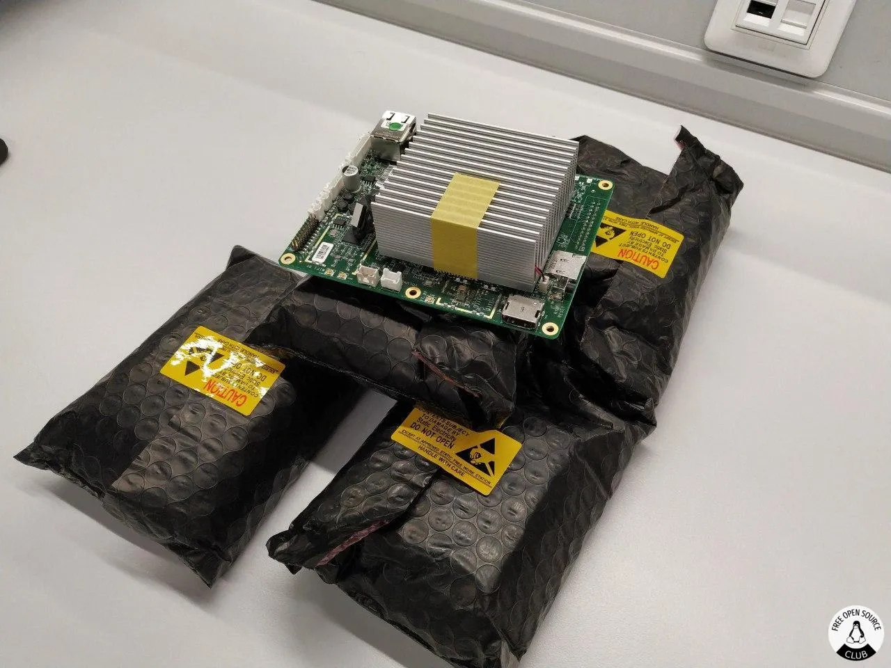 Atomic Pi, an SBC sitting on top of multiple thick envelopes containing more